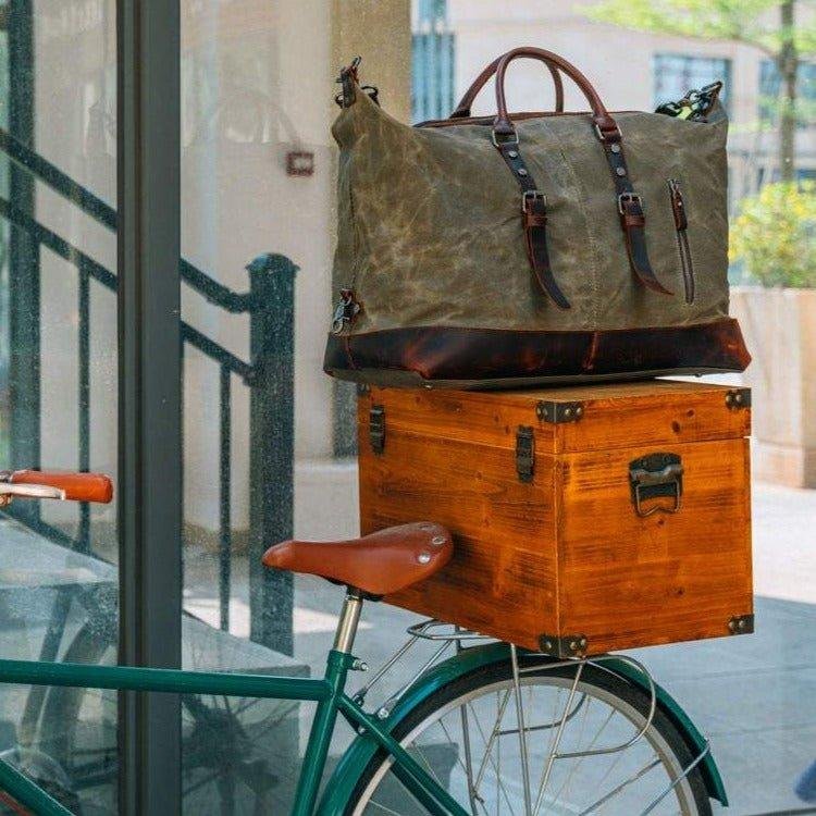 Woosir waxed canvas weekender bag on a bike